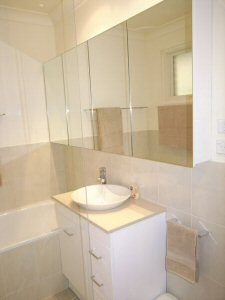 bank of custom built shaving cabinets with mirrored doors